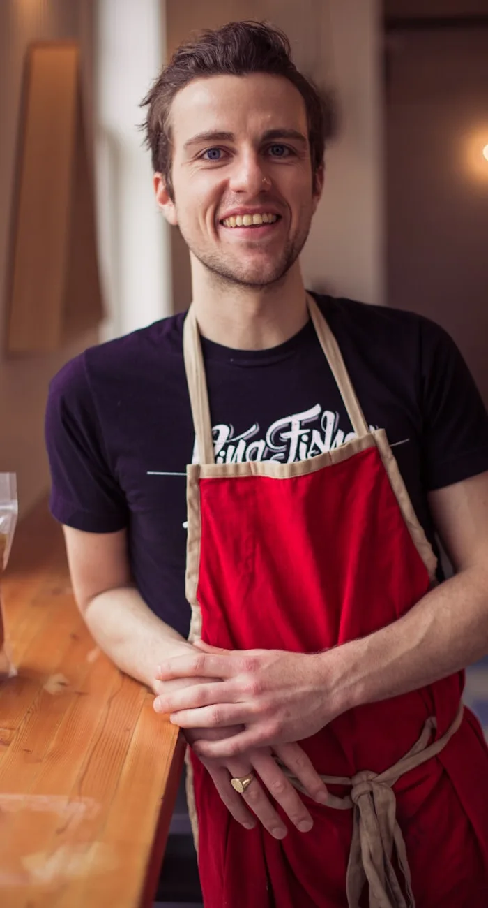 Happy restaurant owner in his kitchen